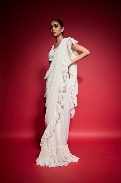 WHITE RUFFLE SAREE WITH EMBROIDERED BLOUSE.
