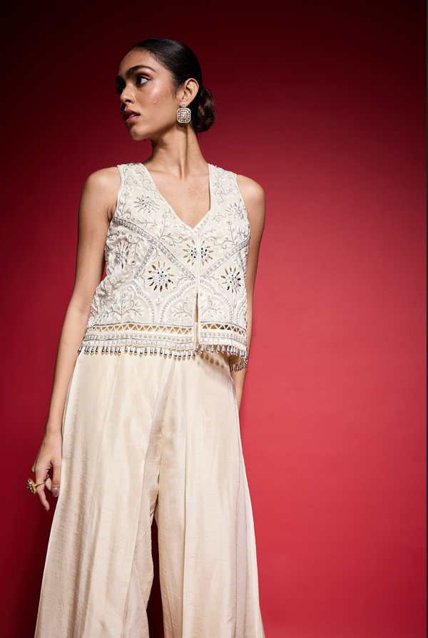 WHITE EMBROIDERED CUTOWRK VEST.