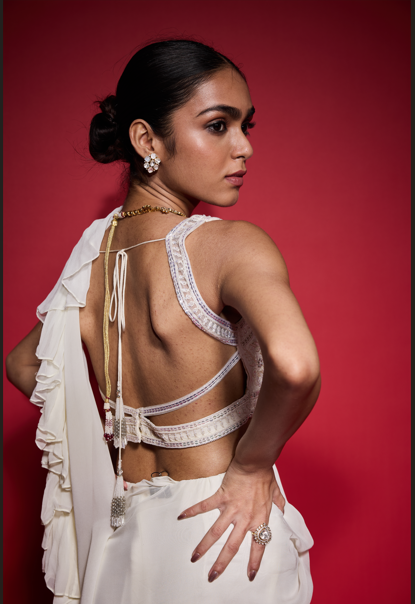 WHITE RUFFLE SAREE WITH EMBROIDERED BLOUSE.