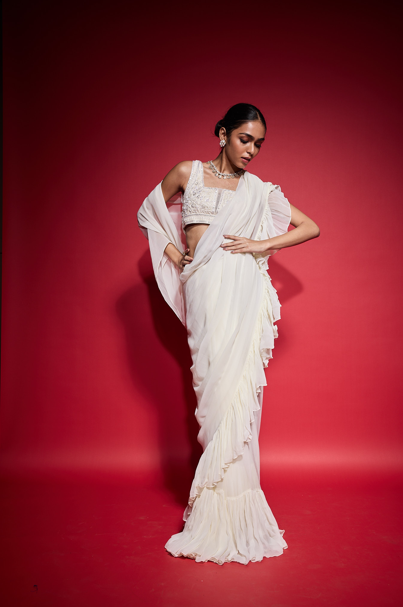 WHITE RUFFLE SAREE WITH EMBROIDERED BLOUSE.