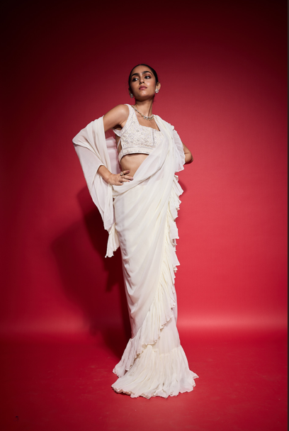 WHITE RUFFLE SAREE WITH EMBROIDERED BLOUSE.