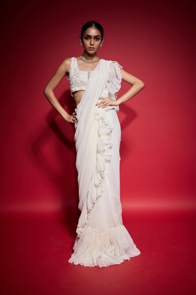 WHITE RUFFLE SAREE WITH EMBROIDERED BLOUSE.