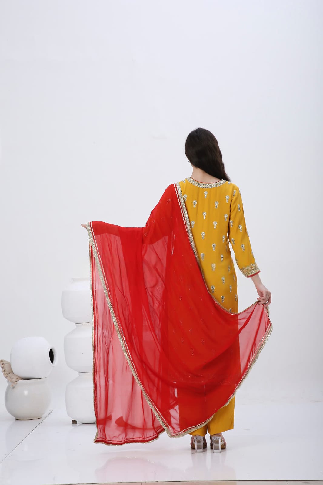 Saffron embroidered kurtaset with red dupatta.