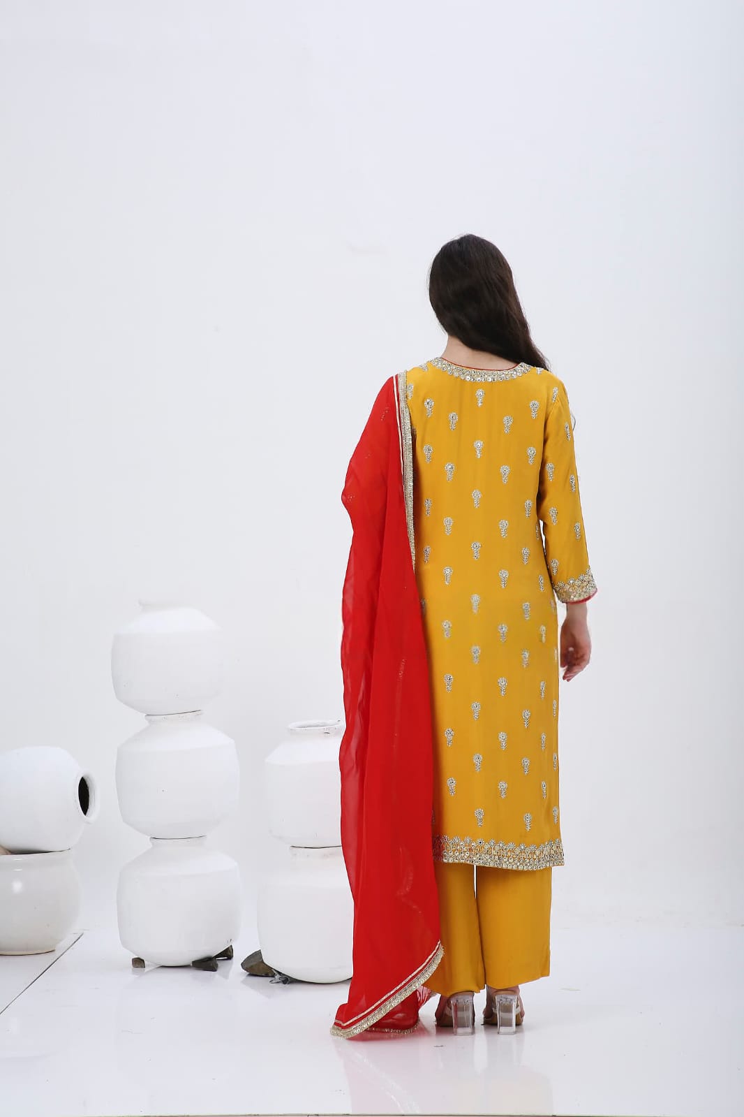 Saffron embroidered kurtaset with red dupatta.