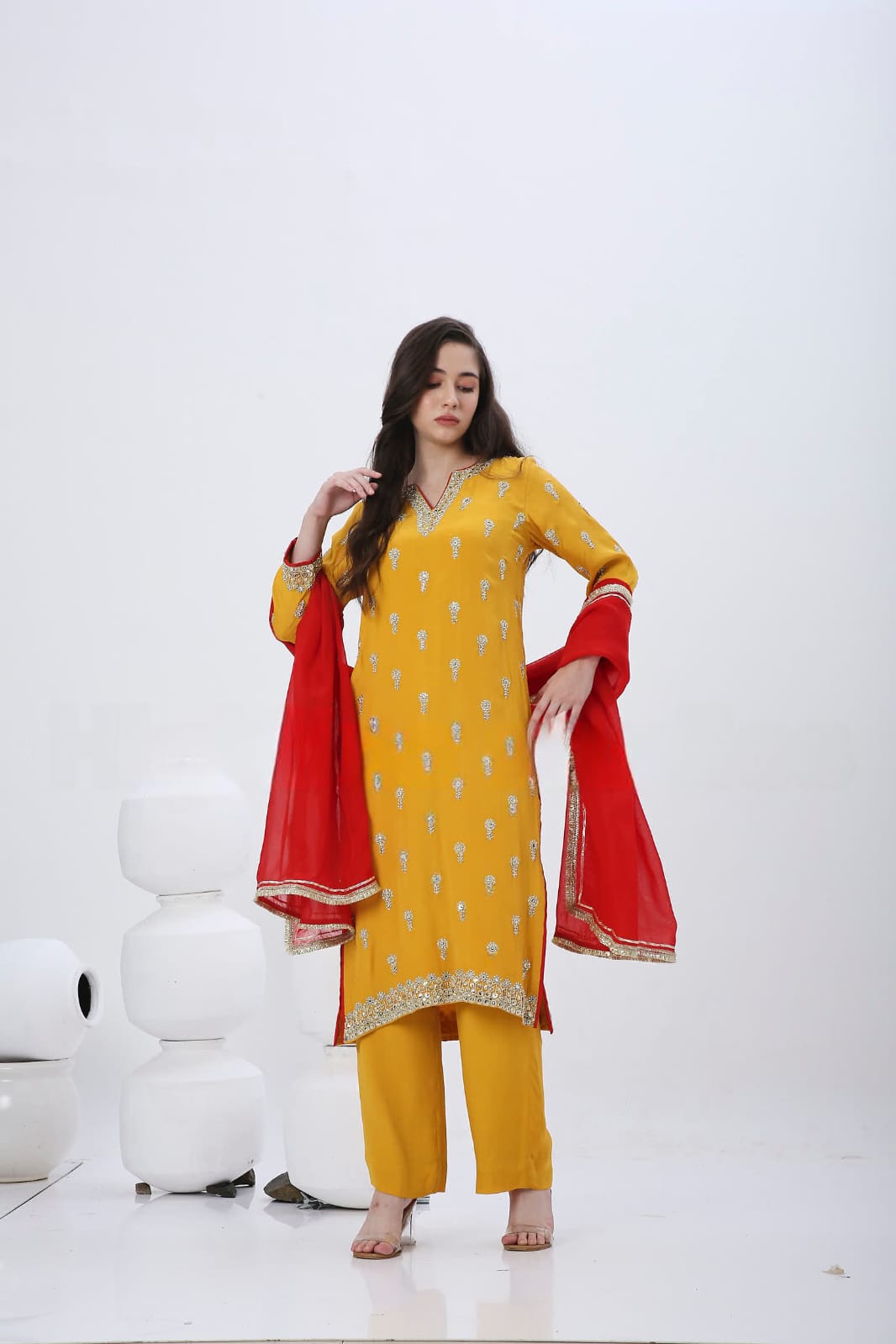 Saffron embroidered kurtaset with red dupatta.