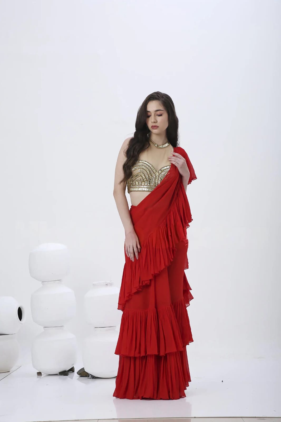 Red prestiched saree.